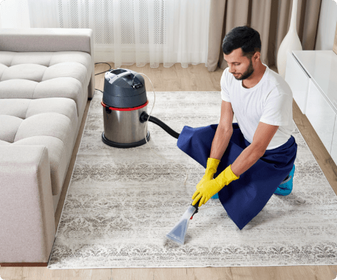 man-cleaning-carpet-living-room-using-vacuum-cleaner